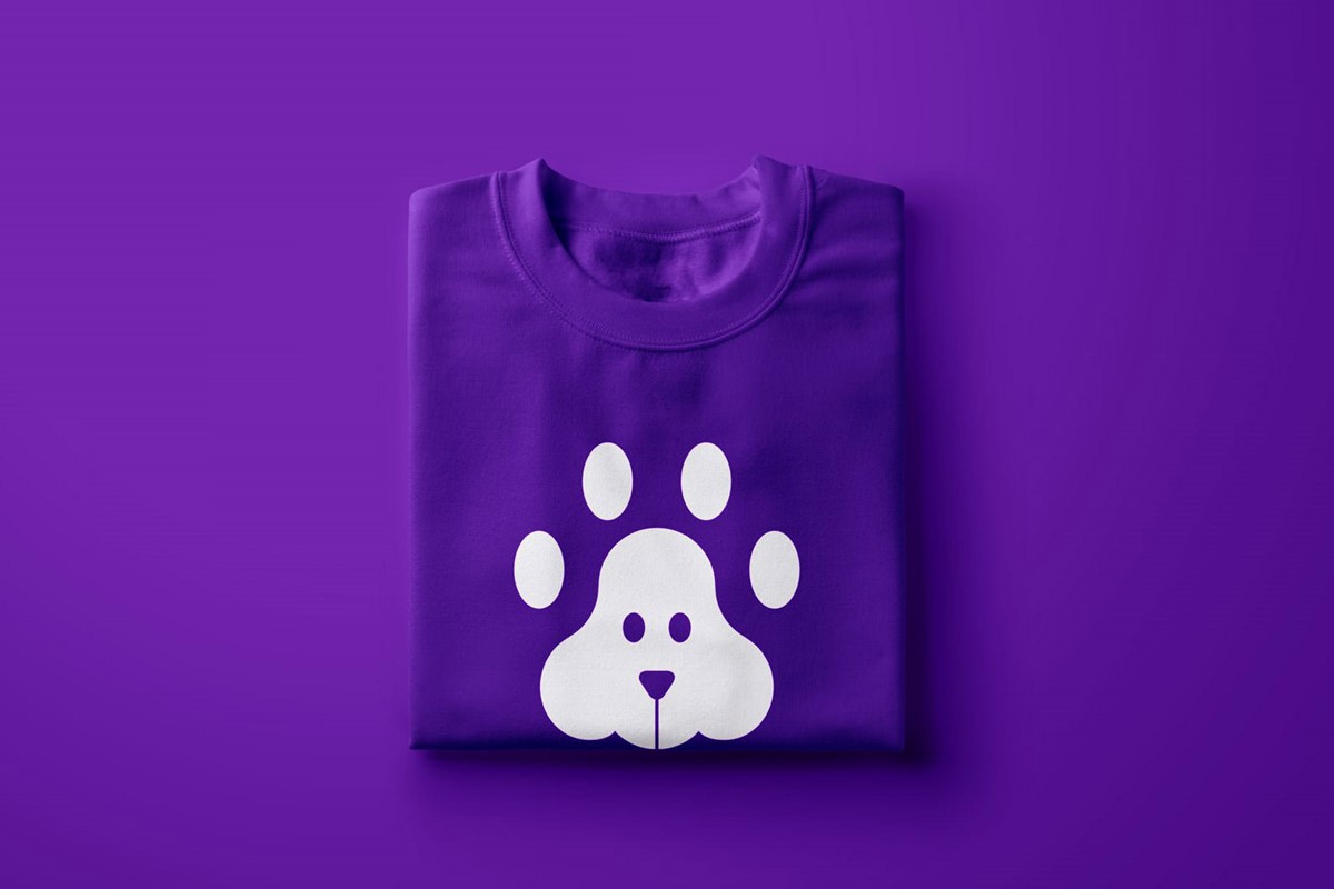 4 Legged Friends identity logo white on folded purple t-shirt mock-up. Design by Superfried.