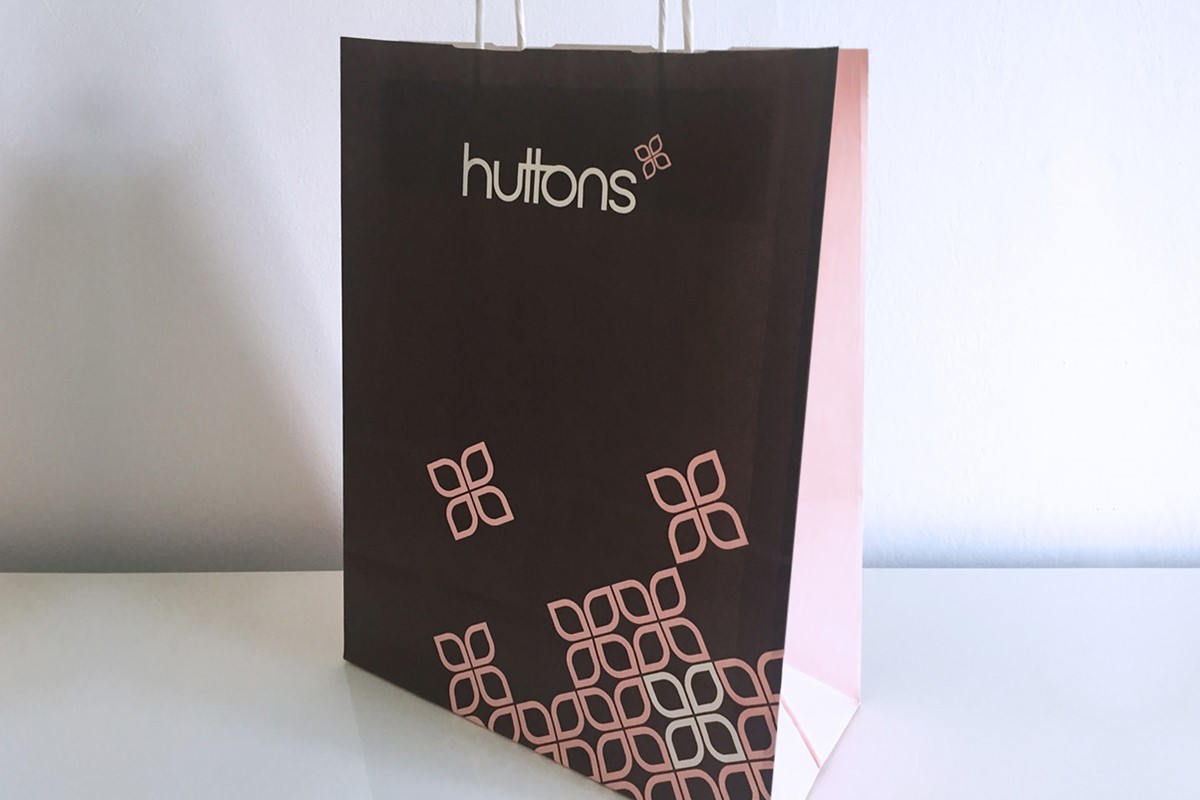 Huttons. Retail brand identity paper shopping bag - logo & brand pattern. Brand identity design by Superfried.