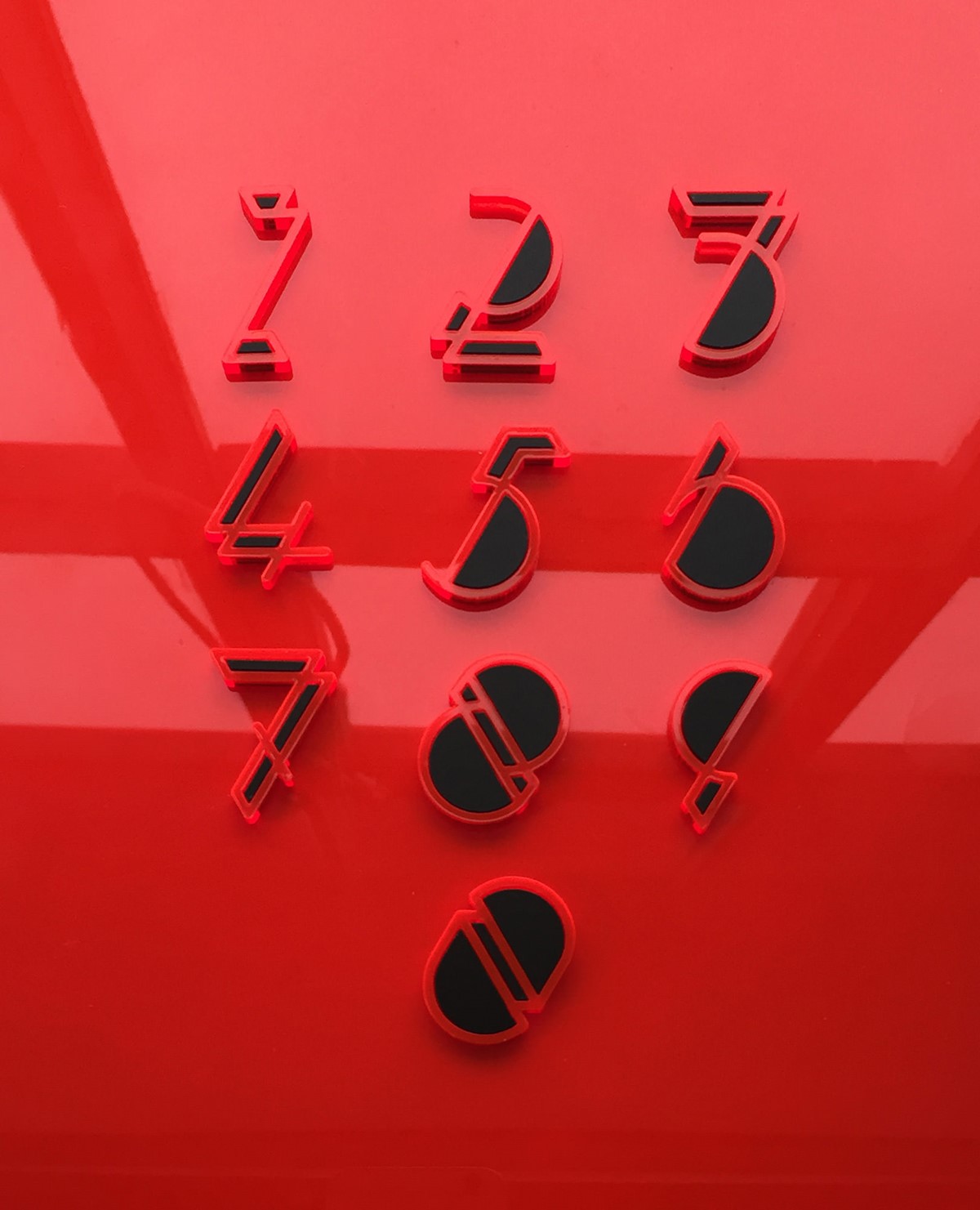 Flex. Fred Aldous. Experimental laser cut numerals on red plastic. Typography design by Superfried.