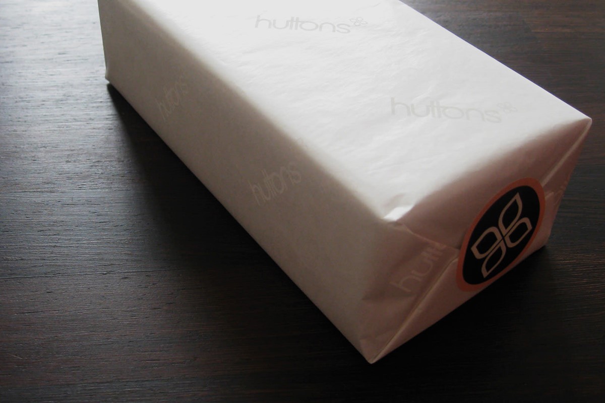 Huttons. Retail packaging - present wrapped in branded tissue paper + logo sticker. Identity design by Superfried.