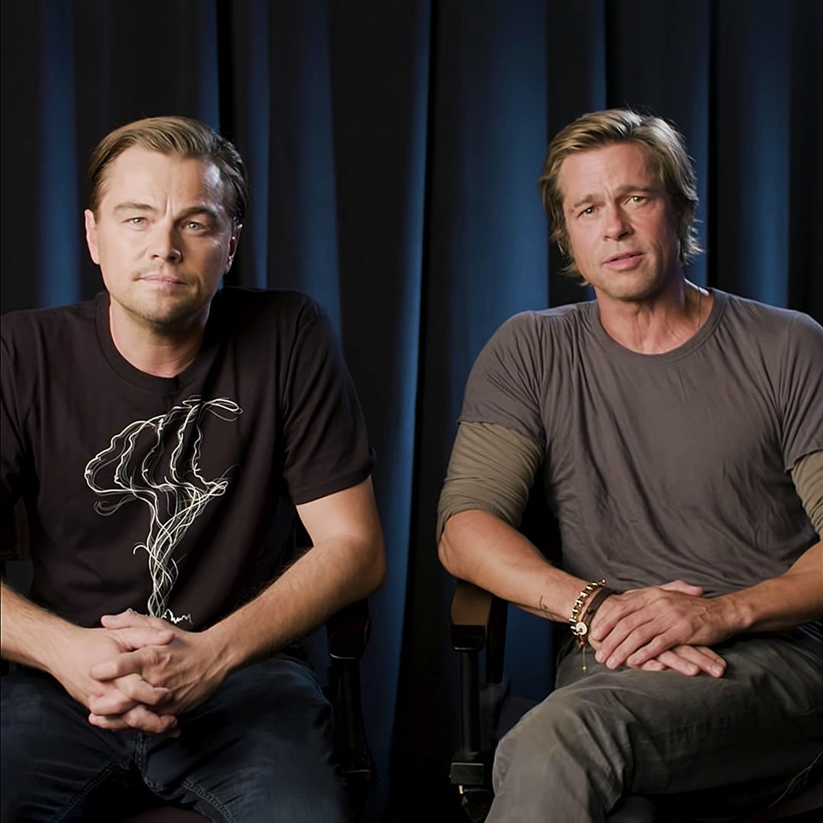 Photo of Brad Pitt sitting next to Leonardo DiCaprio who is wearing the Don't Let Them Disappear campaign t-shirt. Client: Jane Goodall Institute and Dicaprio Foundation.